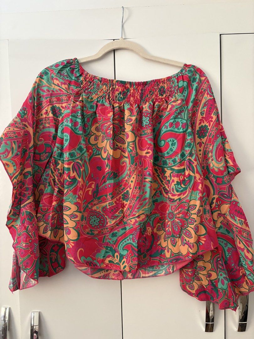 Boho Paisley Off-Shoulder Smocked Blouse (Category: Blouses) located in Pasay City. Submitted by chacha_15 (Listing ID 1448328983, Image 1). Description: - Vibrant off-shoulder top - Bold paisley print - Smocked neckline - Flowy sleeves - Lightweight and airy fabric .