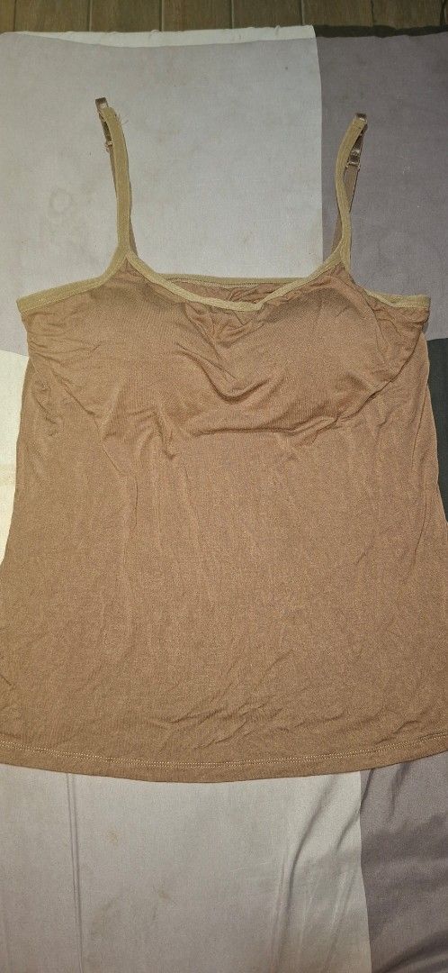 Brown Padded Camisole Tank Top (Category: Sleeveless) located in Valenzuela. Submitted by thriftlets (Listing ID 1448418316, Image 1). Description: - Brown camisole - Built-in padding - Adjustable straps - Soft fabric - Versatile: great for layering or wearing on its own.
