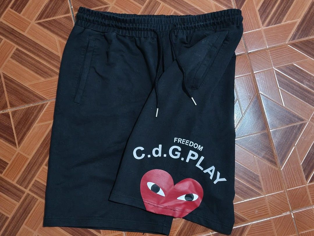 CDG PLAY Black Shorts with Heart Logo (Category: Shorts) located in Gonzaga. Submitted by wornnworthy (Listing ID 1448383373, Image 1). Description: - Brand: CDG PLAY - Color: Black - Size: 2XL - Features: Iconic heart logo, 'FREEDOM' text - Material: Cotton blend - Waistband: Elastic with drawstring - Style: Casual wear.