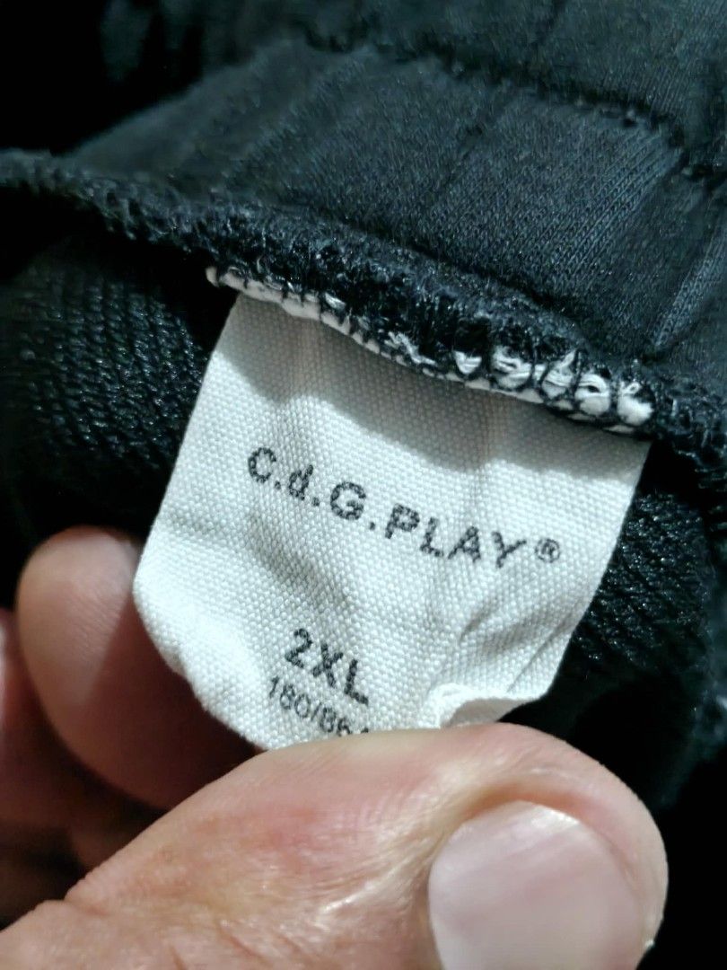 CDG PLAY Black Shorts with Heart Logo (Category: Shorts) located in Gonzaga. Submitted by wornnworthy (Listing ID 1448383373, Image 2). Description: - Brand: CDG PLAY - Color: Black - Size: 2XL - Features: Iconic heart logo, 'FREEDOM' text - Material: Cotton blend - Waistband: Elastic with drawstring - Style: Casual wear.