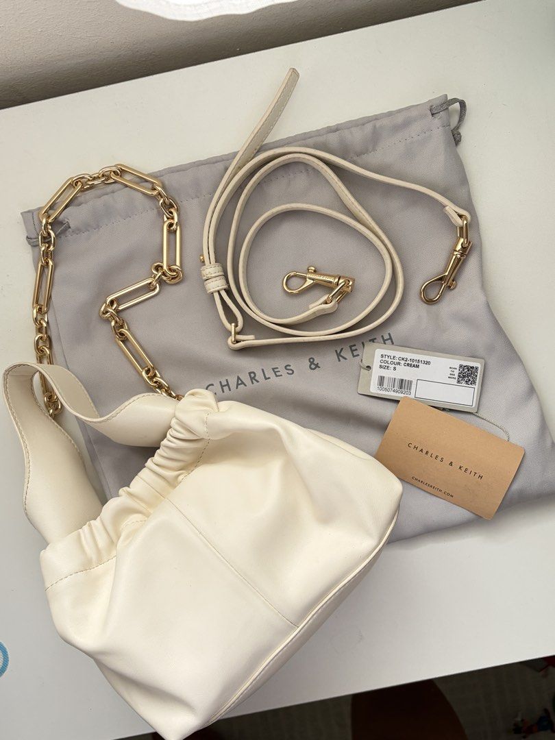 Charles & Keith - Ally Ruched Dumpling Bag (Cream) (Category: Shoulder Bags) located in Quezon City. Submitted by nikerlle (Listing ID 1448325453, Image 1). Description: - 8/10 condition, almost like new - Ruched design, dumpling bag. I think their inspo here is Polene Neuf - Comes with original CK dust bag and tags - Includes a detachable long strap, chain handle (not tarnished yet) - Guaranteed authentic, bought this from Glorietta no more pape