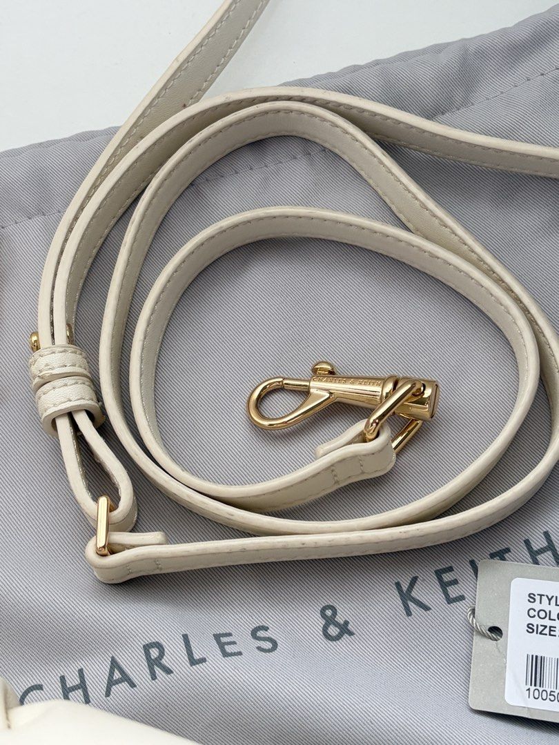 Charles & Keith - Ally Ruched Dumpling Bag (Cream) (Category: Shoulder Bags) located in Quezon City. Submitted by nikerlle (Listing ID 1448325453, Image 2). Description: - 8/10 condition, almost like new - Ruched design, dumpling bag. I think their inspo here is Polene Neuf - Comes with original CK dust bag and tags - Includes a detachable long strap, chain handle (not tarnished yet) - Guaranteed authentic, bought this from Glorietta no more pape