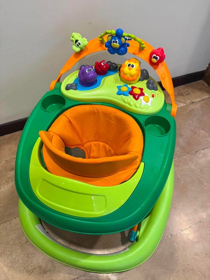 Chicco Baby Walker with Activity Tray (Category: Infant Playtime) located in Paranaque City. Submitted by reviverack1993 (Listing ID 1448458881, Image 2). Description: - Green and orange baby walker - Features a fun activity tray with toys - Padded orange seat for comfort - Ideal for babies learning to walk - Easy to maneuver - Still in good working order.