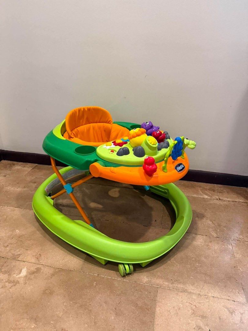 Chicco Baby Walker with Activity Tray (Category: Infant Playtime) located in Paranaque City. Submitted by reviverack1993 (Listing ID 1448458881, Image 1). Description: - Green and orange baby walker - Features a fun activity tray with toys - Padded orange seat for comfort - Ideal for babies learning to walk - Easy to maneuver - Still in good working order.