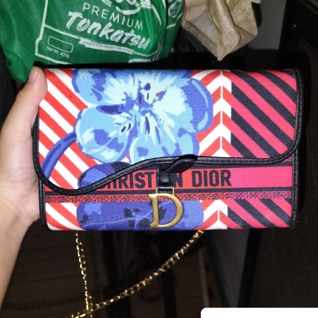 Christian Dior Wallet with Chain (Category: Luxury Bags & Wallets) located in Manila. Submitted by retsuya4 (Listing ID 1448394336, Image 1). Description: - Authentic Christian Dior wallet - Eye-catching floral print in red, white, and blue - Includes a stylish chain strap for easy carrying - Adorned with the iconic 'CD' logo hardware - Ideal for keeping your essentials organized and accessible.