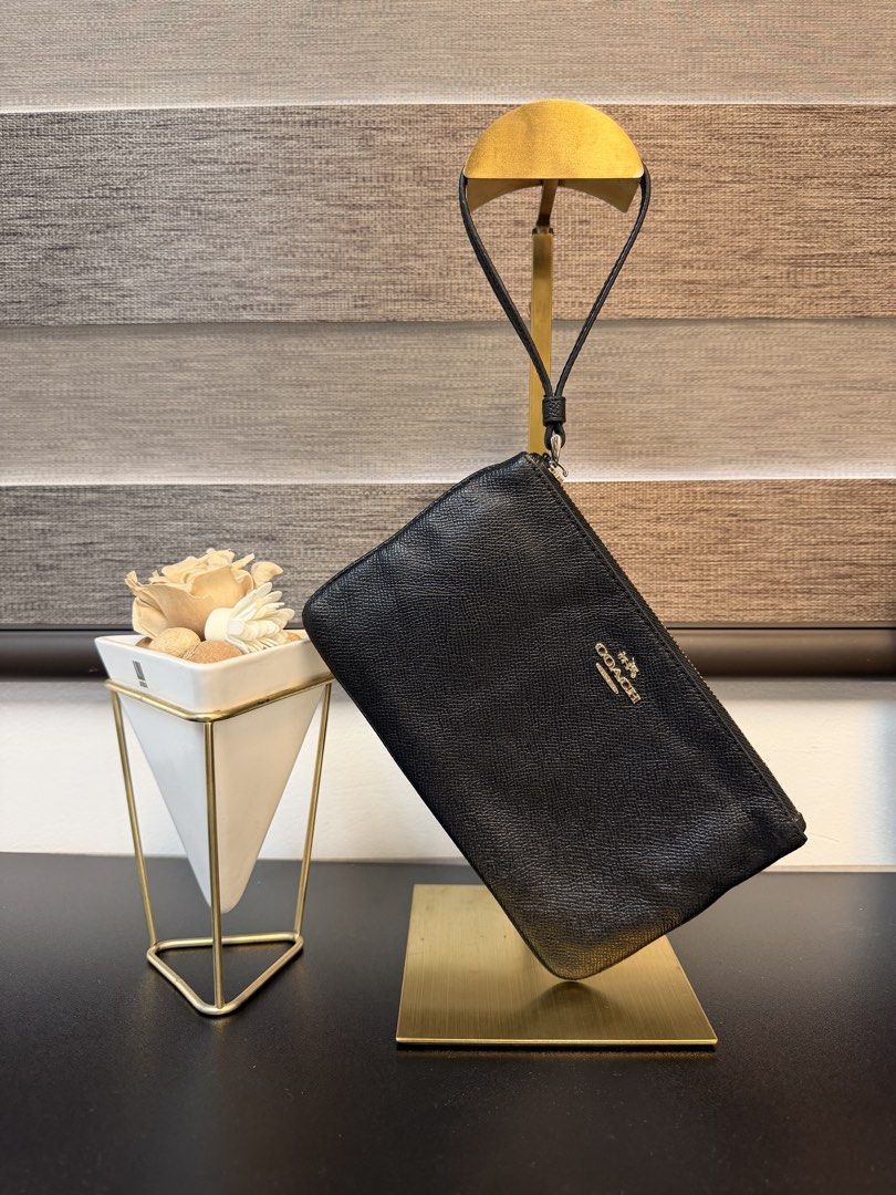Coach Black Leather Wristlet Clutch (Category: Clutches) located in Makati City. Submitted by bagattic_etc (Listing ID 1448322344, Image 1). Description: Coach black leather wristlet with embossed logo. Detachable strap. Perfect for essentials, day or night. Made in Philippines.