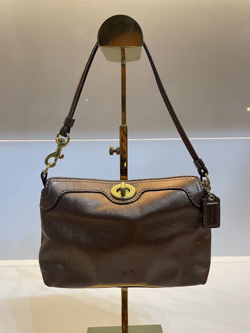 Coach Brown Leather Shoulder Bag with Turnlock Closure (Category: Luxury Bags & Wallets) located in Davao. Submitted by ishuh (Listing ID 1448395501, Image 1). Description: - Authentic Coach brown leather shoulder bag - Classic turnlock closure on the front - Beautiful leather sheen - Secure hook closure on the strap - Includes small Coach tag - Perfect for daily use.