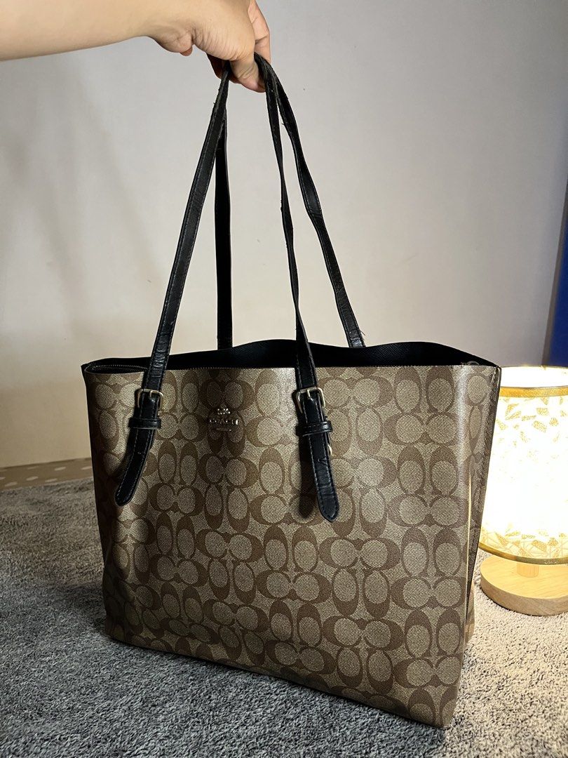Coach Monogram Canvas Tote Bag (Category: Luxury Bags & Wallets) located in Malaybalay. Submitted by yanshoppe (Listing ID 1448433731, Image 1). Description: - Classic Coach tote bag - Brown monogram canvas with black leather trim - Spacious interior, ideal for everyday or travel - Secure top zip closure - Comfortable double shoulder straps - A versatile bag for all your essentials.