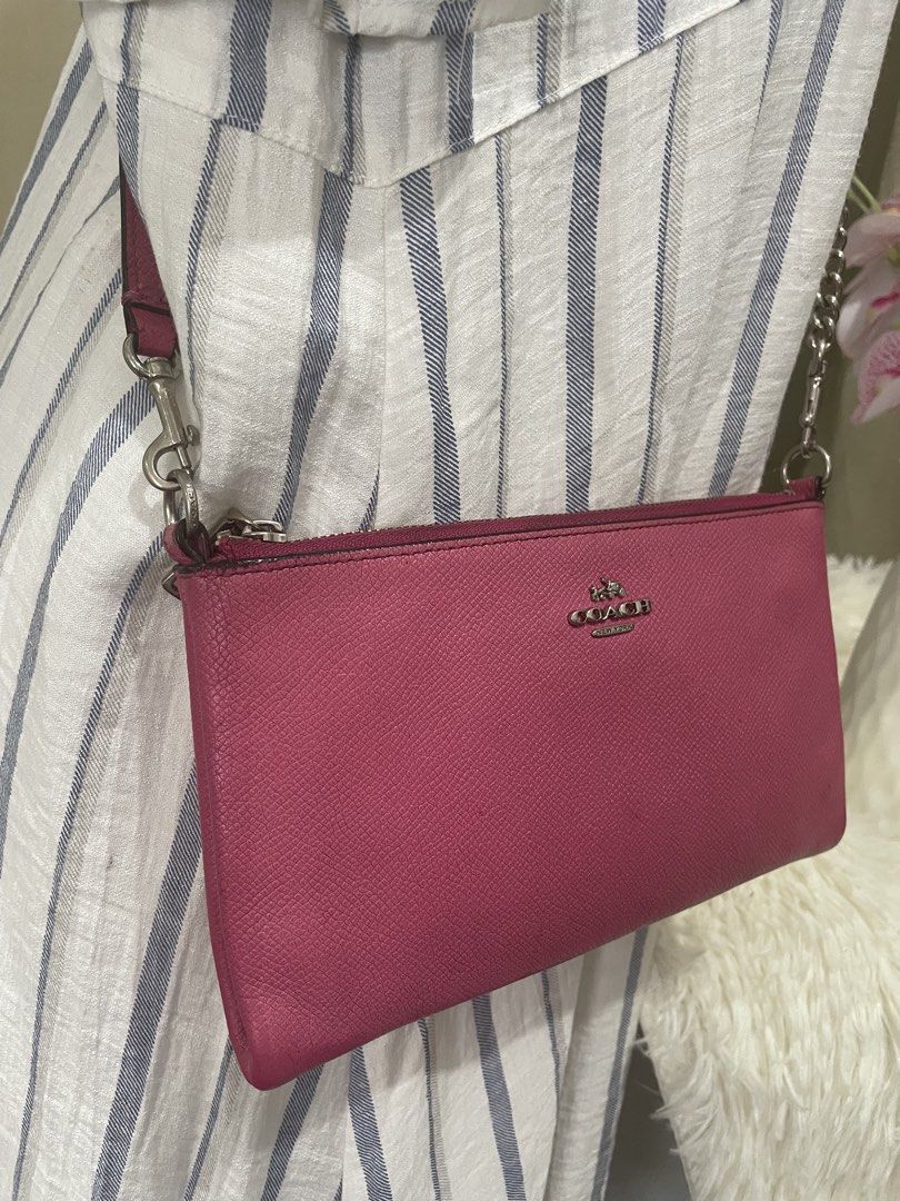 Coach Pink Crossbody Bag (Category: Luxury Bags & Wallets) located in Cabanatuan. Submitted by moraiahraven (Listing ID 1448479359, Image 2). Description: Pre-loved but well-maintained. Minor signs of use (light marks on back pocket area), overall clean and still looks fresh. Super chic and practical! Great for running errands, casual outings, or pairing with dresses..