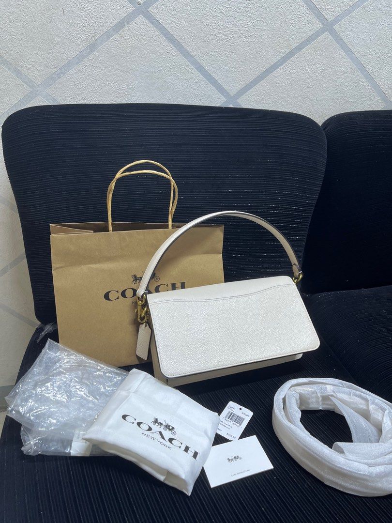 Coach Tabby Shoulder Bag 26 White Pebble Leather (Category: Shoulder Bags) located in San Pablo. Submitted by isshhhhh (Listing ID 1448445899, Image 2). Description: - Authentic Coach Tabby Bag - Color: White - Material: Pebble Leather - Hardware: Brass with iconic C logo - Includes: Dust bag, paper bag, and strap - Interior: Zip pocket and slip pockets - Versatile: Ideal for everyday or nights out.