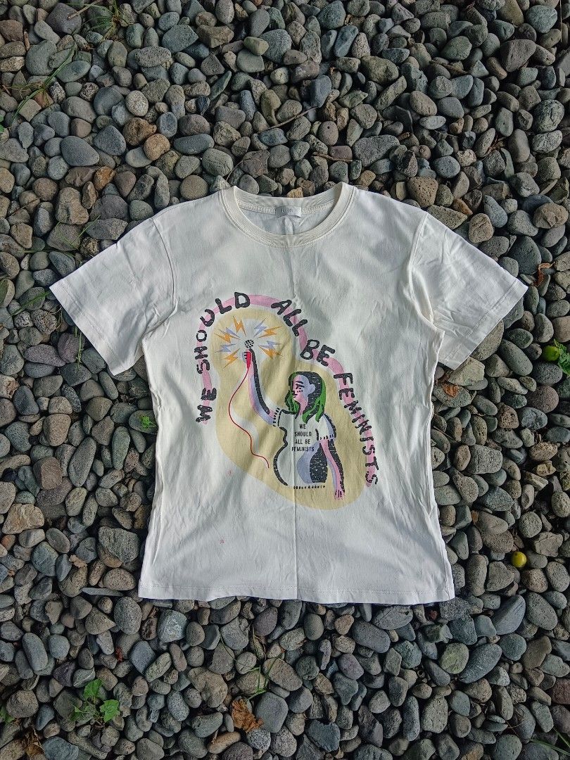 Dior T-shirt with Graphic Print (Category: Shirts) located in Tarlac. Submitted by khrizson16 (Listing ID 1448366674, Image 1). Description: - Cream colored Dior t-shirt - Features 'SHOULD WE ALL BE FEMINISTS' graphic print on the front - Classic crew neck and short sleeves - Plain back - Perfect for making a statement.