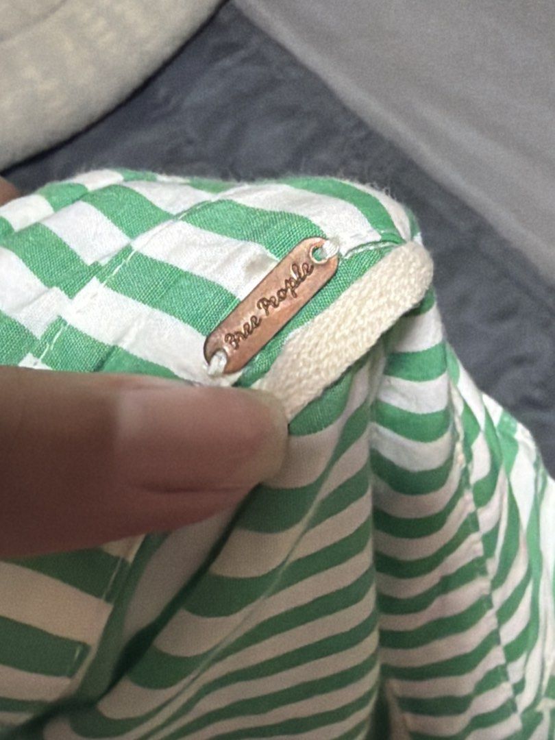 Free People Green Striped Wrap Romper (Category: Rompers) located in Manila. Submitted by tpdcz (Listing ID 1448405684, Image 3). Description: - Cute green and white striped romper from Free People. - Features a stylish wrap-style top and comfortable shorts. - Cuffed sleeves add a chic detail. - Made from light and breezy material, perfect for summer. - Ideal for a comfy and stylish casual day out..