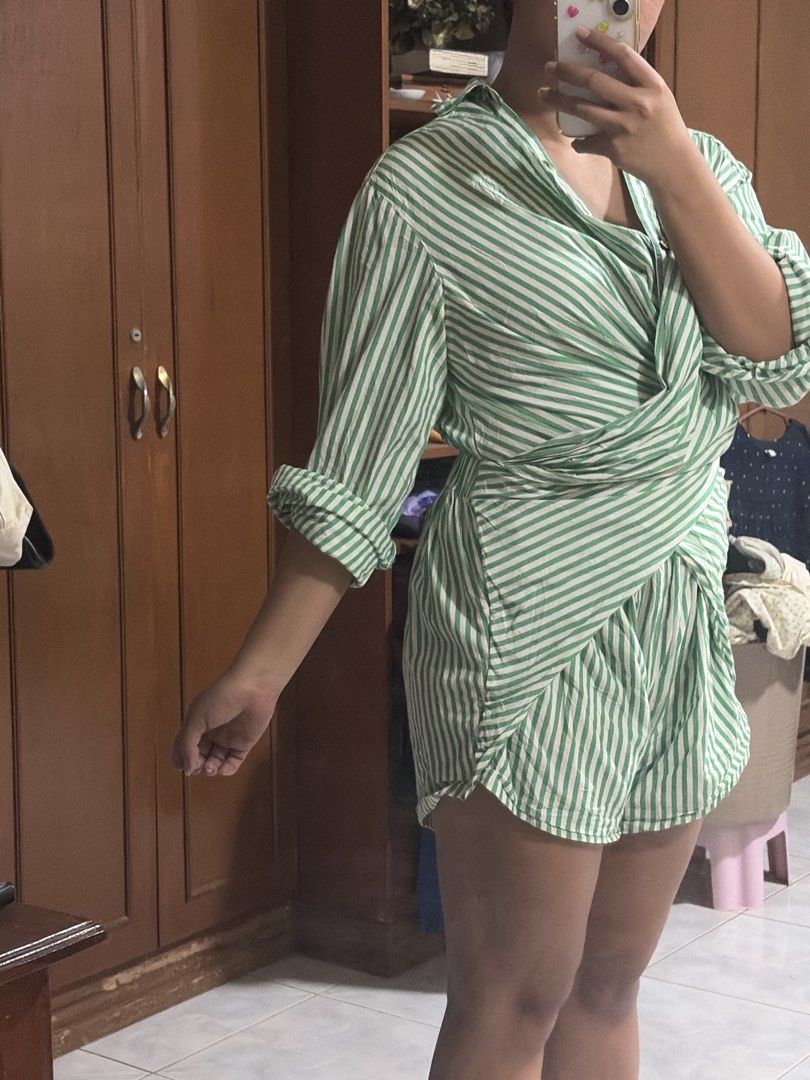 Free People Green Striped Wrap Romper (Category: Rompers) located in Manila. Submitted by tpdcz (Listing ID 1448405684, Image 2). Description: - Cute green and white striped romper from Free People. - Features a stylish wrap-style top and comfortable shorts. - Cuffed sleeves add a chic detail. - Made from light and breezy material, perfect for summer. - Ideal for a comfy and stylish casual day out..