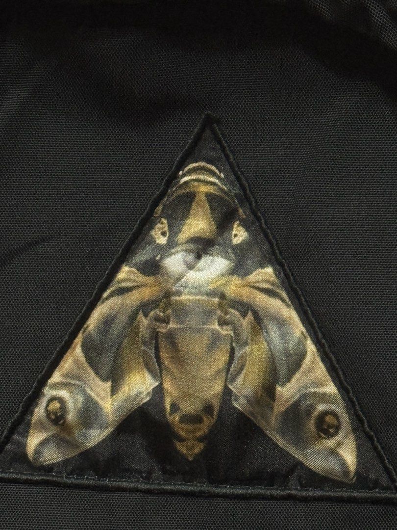 Givenchy Black Nylon Backpack with Moth Emblem (Category: Luxury Bags & Wallets) located in Makati City. Submitted by vinsanity41546 (Listing ID 1448445368, Image 2). Description: - Authentic Givenchy black nylon backpack - Features iconic moth emblem on the front - "REAL EYES. REALIZE. REAL LIES." text detail - Adjustable straps for comfortable wear - Stylish leather accents - Ideal for everyday use and travel.