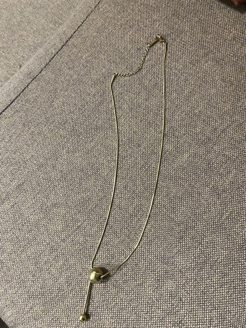 Gold Ball Pendant Necklace (Category: Necklaces) located in Makati City. Submitted by dpjanssen (Listing ID 1448438117, Image 3). Description: - Simple gold necklace - Unique ball pendant design - Delicate and adjustable chain - Ideal for layering or wearing solo - Minimalist style, complements any outfit -last price posted.