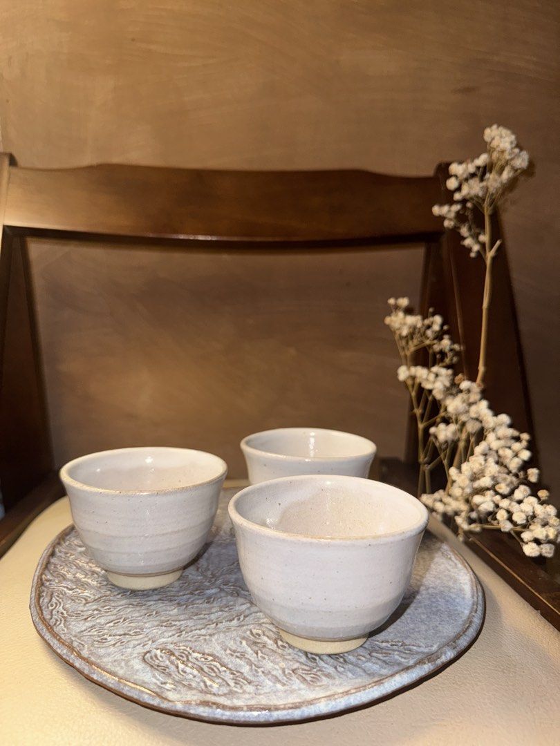 Handmade Stoneware Tea Cups/small soup Set (Category: Coffee & Tea Tableware) located in Makati City. Submitted by crystalwavescollection (Listing ID 1448299765, Image 1). Description: - Set includes 3 small cups - Cups have a rustic, handmade feel with a light glaze. - Perfect for enjoying tea or sake. - Saucer features a unique, wave-like pattern. - Adds a cozy, artisanal touch to your table..