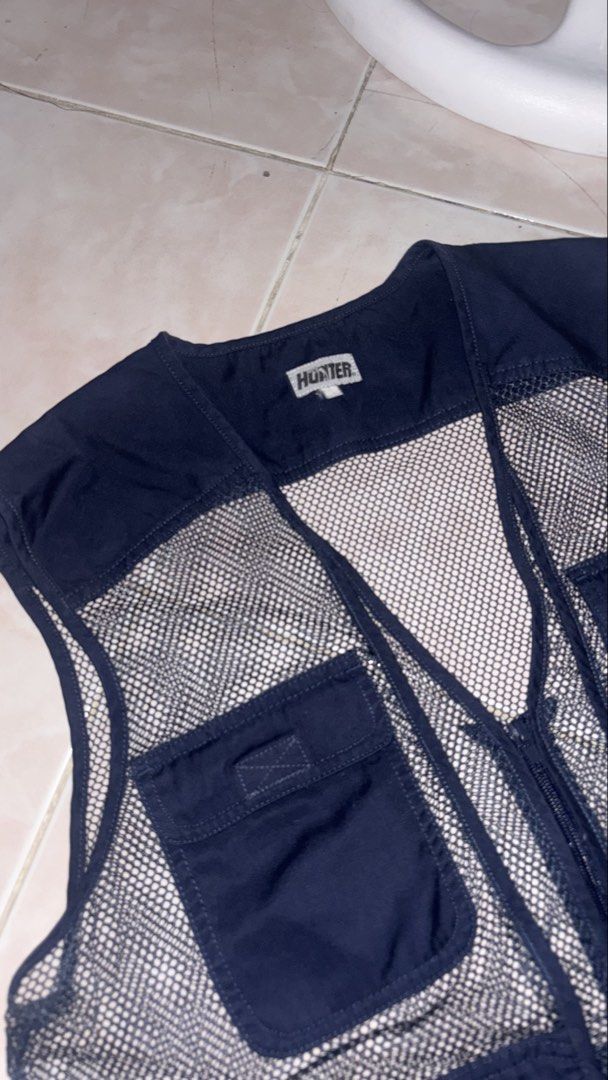 Hunter Navy Mesh Utility Vest (Category: Vests) located in Taguig. Submitted by elymalbueso (Listing ID 1448283105, Image 2). Description: - Hunter navy blue utility vest - Features a breathable mesh back - Multiple chest pockets for easy access - Secure zipper closure - Ideal for outdoor adventures or as a stylish layering piece - Ample storage with numerous pockets.