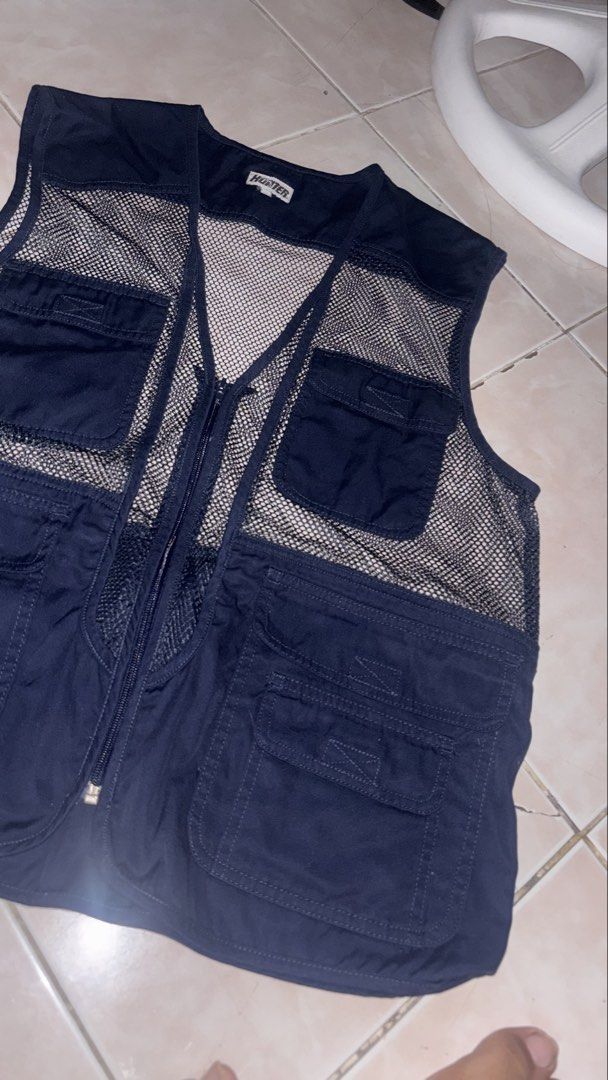 Hunter Navy Mesh Utility Vest (Category: Vests) located in Taguig. Submitted by elymalbueso (Listing ID 1448283105, Image 3). Description: - Hunter navy blue utility vest - Features a breathable mesh back - Multiple chest pockets for easy access - Secure zipper closure - Ideal for outdoor adventures or as a stylish layering piece - Ample storage with numerous pockets.