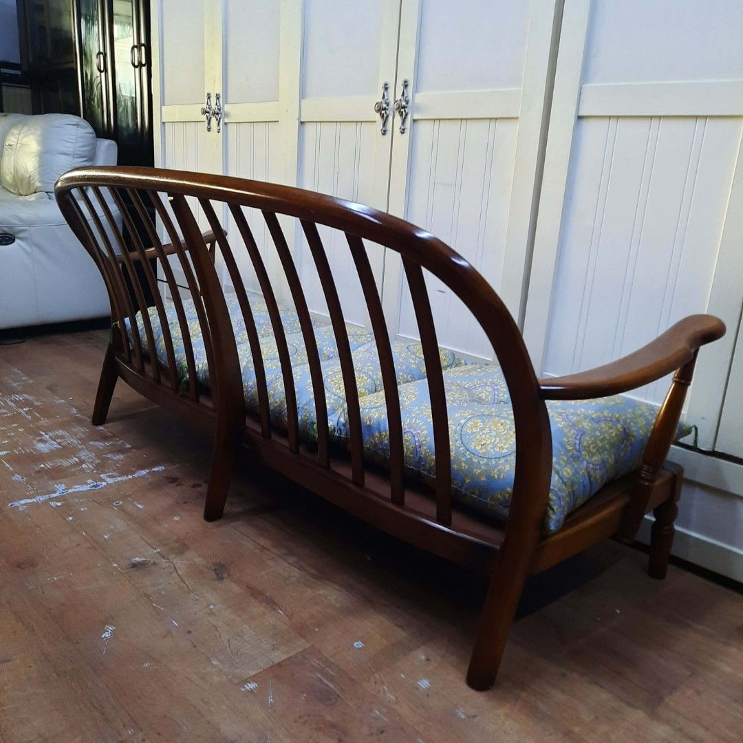 Karimoku Wooden Sofa with Cushions (Category: Sofas) located in Manila. Submitted by ivan_furnitures421 (Listing ID 1448300310, Image 3). Description: - Classic Karimoku wooden sofa - Features curved backrest and armrests - Comes with 3 seat cushions and 2 back cushions - Upholstered in a blue and yellow patterned fabric - Warm, rich wood tone - Ideal for living rooms or as a statement piece - Approximate dimensions: [insert dimensions here if kn