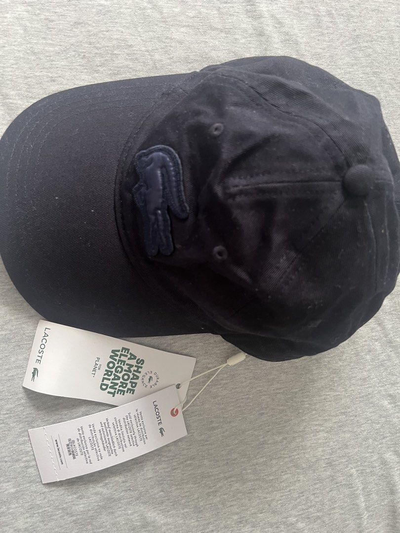 Lacoste Navy Blue Cotton Cap with Tag (Category: Caps & Hats) located in Muntinlupa City. Submitted by 09leah77 (Listing ID 1448284224, Image 3). Description: - Navy blue Lacoste cap - Made from 100% cotton - One size fits all - Comes with original tags - Ideal for everyday wear - Simple and classic design.