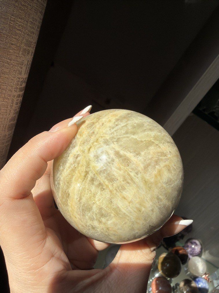 Large Natural Yellow Moonstone Sphere Crystal Ball (Category: Other Home Decor) located in Manila. Submitted by _tala_17 (Listing ID 1448277847, Image 3). Description: - Beautiful large yellow moonstone sphere - Features lovely natural inclusions and patterns - Catches the light beautifully - Ideal for display or energy work - Comes with a clear stand - Measures approximately [insert size here if known].