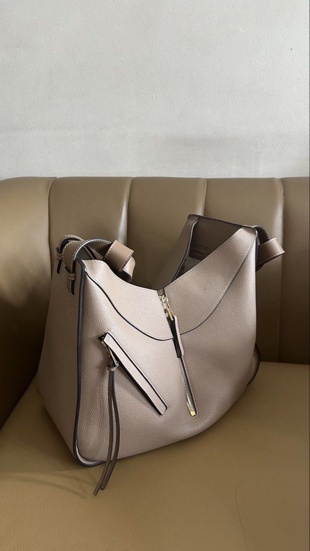 Loewe Hammock Bag in Grained Calfskin (Category: Luxury Bags & Wallets) located in Manila. Submitted by ther3se (Listing ID 1448359131, Image 3). Description: - Taupe Grained calfskin leather - Includes dust bag - Good condition - Has a minor edge chip and faint marker dot - Versatile and interior is spacious.