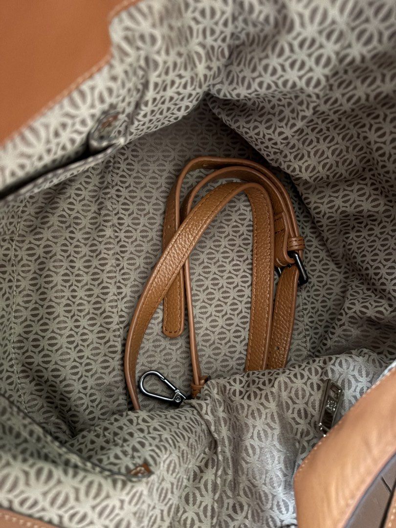 LQ Monogram Canvas Leather Shoulder Bag (Category: Luxury Bags & Wallets) located in Makati City. Submitted by goodfindsonly (Listing ID 1448347536, Image 3). Description: - LQ Anagram shoulder bag - Beige canvas with brown leather trim - Features iconic Loewe anagram pattern - Comes with a detachable strap - Adorned with a metal logo tag - Ideal for everyday carry.