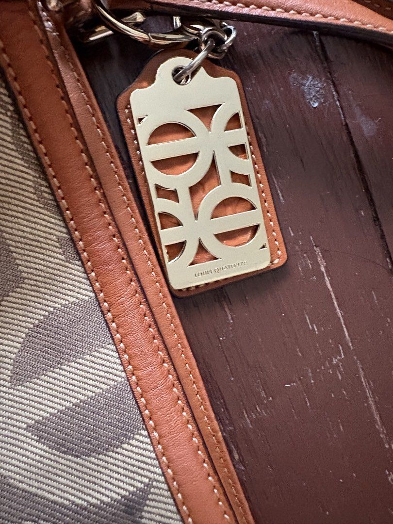 LQ Monogram Canvas Leather Shoulder Bag (Category: Luxury Bags & Wallets) located in Makati City. Submitted by goodfindsonly (Listing ID 1448347536, Image 2). Description: - LQ Anagram shoulder bag - Beige canvas with brown leather trim - Features iconic Loewe anagram pattern - Comes with a detachable strap - Adorned with a metal logo tag - Ideal for everyday carry.