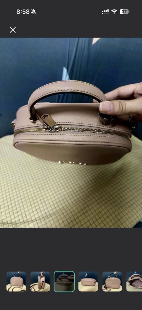 LOVCAT Pink Chain Strap Top Handle Bag (Category: Luxury Bags & Wallets) located in Manila. Submitted by cvmpreloved1212 (Listing ID 1448406927, Image 3). Description: - Cute pink LOVECAT handbag - Features a top handle - Includes a detachable chain strap - Secure zipper closure - Small and compact, ideal for carrying essentials - Versatile for casual outings or dressing up an outfit - Shows minimal signs of wear.