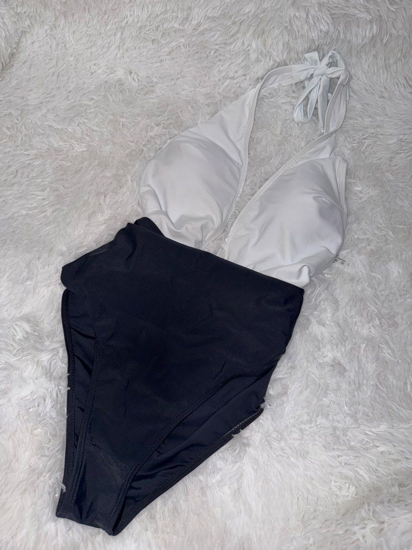 Low cut Two-tone Halter Neck One-Piece Swimsuit (Category: Bikinis & Swimsuits) located in Lipa City. Submitted by princesstrina (Listing ID 1448444677, Image 1). Description: White halter top with a black high-waisted bottom. Ties at the neck for adjustable fit. Classic color blocking design. Great for the beach or pool. Ready for your next vacation!.