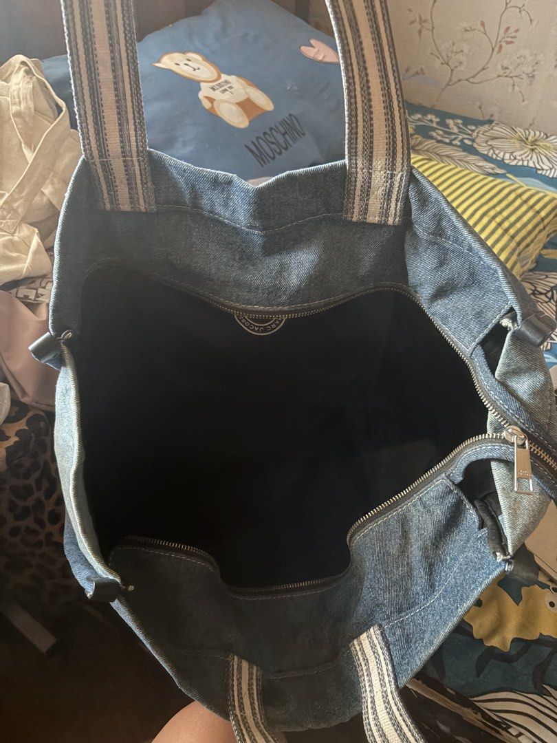 Marc Jacobs Denim Tote Bag Est. 1984 (Category: Luxury Bags & Wallets) located in San Pedro. Submitted by AuthenticBrandedItems (Listing ID 1448374636, Image 3). Description: - Classic Marc Jacobs denim tote bag - Features iconic 'Est. 1984' logo - Spacious interior with zip closure - Comfortable shoulder straps - Durable and stylish denim material - Ideal for everyday use or travel.