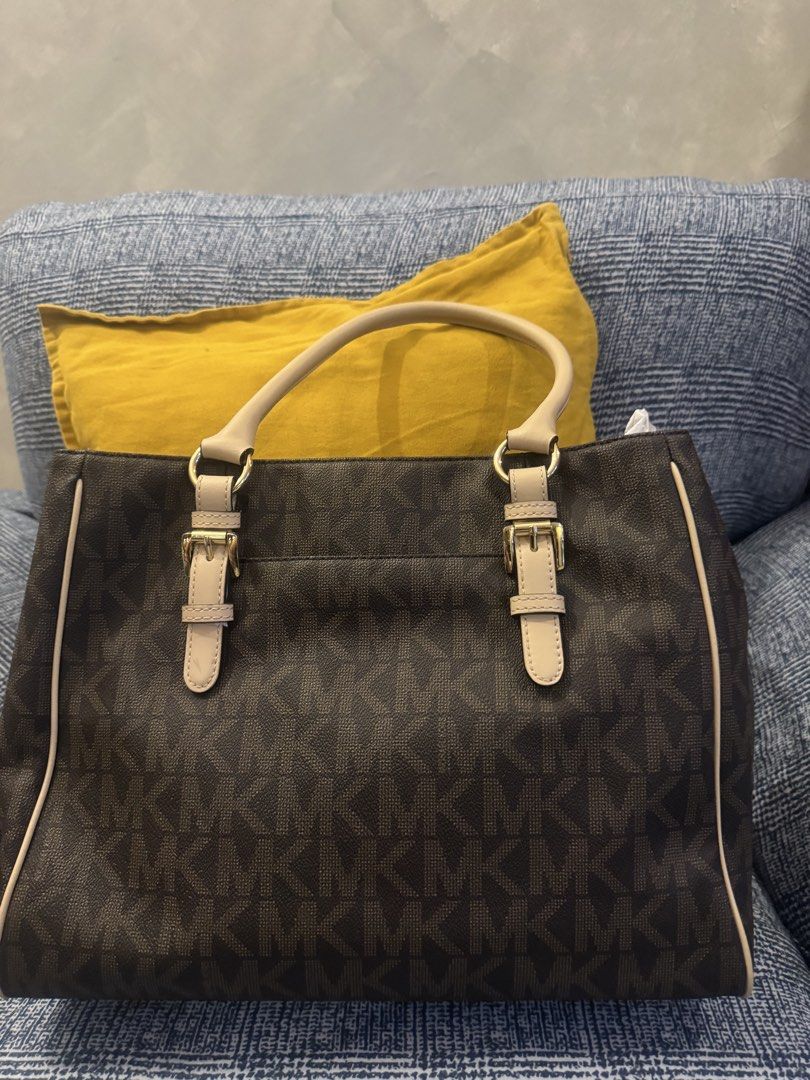 Michael Kors Monogram Tote Bag Brown (Category: Luxury Bags & Wallets) located in Santa Maria. Submitted by tropique (Listing ID 1448417039, Image 3). Description: - Classic Michael Kors tote bag - Brown monogram print with beige trim and handles - Gold tone hardware - Multiple interior pockets for organization - Comes with authenticity card - Great everyday bag.