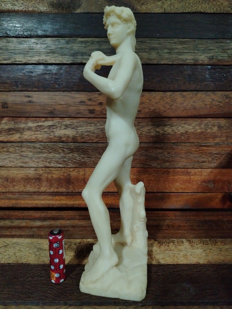 Michelangelo's David Statue Replica (Category: Other Home Decor) located in San Jose del Monte. Submitted by toys.merch.electronic (Listing ID 1448364060, Image 3). Description: - Replica of Michelangelo's iconic David statue. - Crafted from a cream-colored material (likely resin or plaster). - Features impressive detail, capturing the statue's pose and musculature. - Stands on a realistic rocky base. - Ideal for home decor, display, or as a uniq