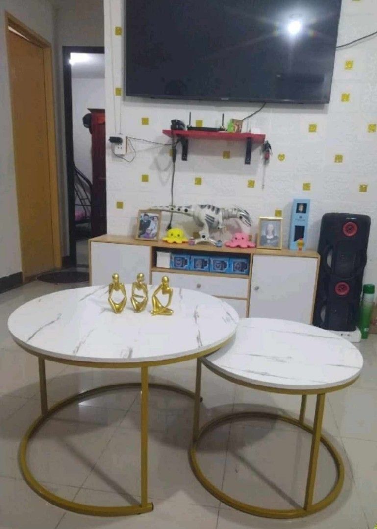 Nesting Marble Coffee Tables with Gold Legs (Category: Tables & Sets) located in Manila. Submitted by mightycloud_1992 (Listing ID 1448294842, Image 3). Description: - Set of two nesting coffee tables - White marble tops with elegant gold metal legs - Larger table fits over the smaller one for space-saving convenience - Versatile: use together or separately - Perfect for living rooms, small apartments, or any modern space.