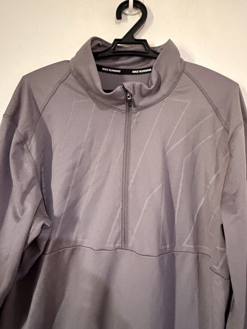 Nike Running Quarter Zip Long Sleeve Men's M (Category: Activewear) located in Manila. Submitted by bookman23 (Listing ID 1448313397, Image 2). Description: - Grey Nike Running Long Sleeve Top - Quarter zip design - Size: Medium - Material: 100% Polyester - Made in Thailand - Ideal for running and workouts - Comfortable and breathable fabric.
