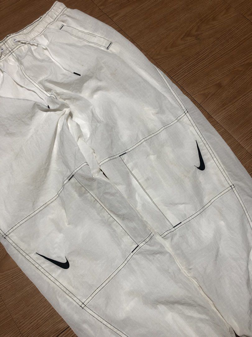 Nike White Track Pants Joggers Size L (Category: Joggers) located in Quezon City. Submitted by yeahsource222 (Listing ID 1448419543, Image 2). Description: - White Nike track pants - Size L - Classic Nike swoosh logo on both legs - Elastic waistband with adjustable drawstring - Two side pockets - Two cargo pockets - Inner mesh lining - Made in China.