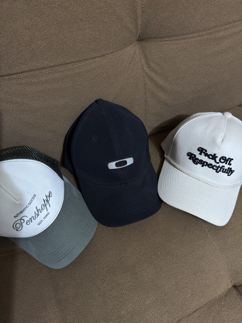 Oakley Cap, Field Grade Cap; Bundle Cap (Category: Caps & Hats) located in Quezon City. Submitted by weeklydeclutter (Listing ID 1448377324, Image 1). Description: SOLD AS SET - Includes a white and green Penshoppe trucker cap. (Needs cleaning) - Features a black garterized Oakley cap. - A white cap with 'Fuck Off Respectfully' Field Grade Brand— embroidery is also included..