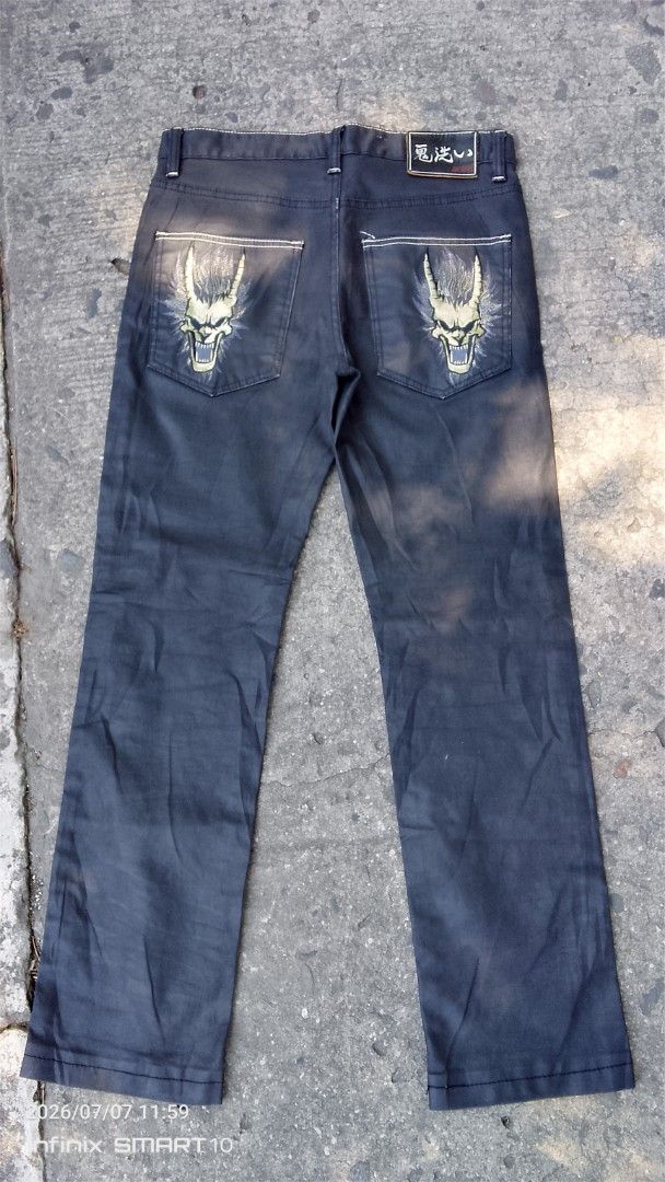 ONARAI Dragon Embroidered Jeans Size 31 (Category: Jeans) located in Manila. Submitted by joseph_thrift (Listing ID 1448419429, Image 1). Description: - Dark wash jeans with unique dragon embroidery on back pockets. - Features a button fly closure. - Made with coated fabric for a distinct look. - Size: W- 31 L- 42 - Please check photos for detailed condition..