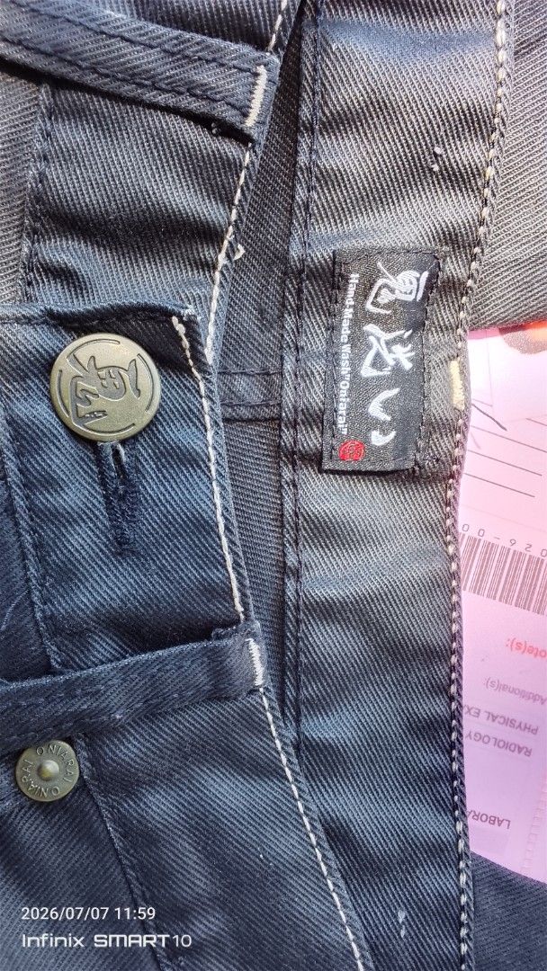 ONARAI Dragon Embroidered Jeans Size 31 (Category: Jeans) located in Manila. Submitted by joseph_thrift (Listing ID 1448419429, Image 3). Description: - Dark wash jeans with unique dragon embroidery on back pockets. - Features a button fly closure. - Made with coated fabric for a distinct look. - Size: W- 31 L- 42 - Please check photos for detailed condition..