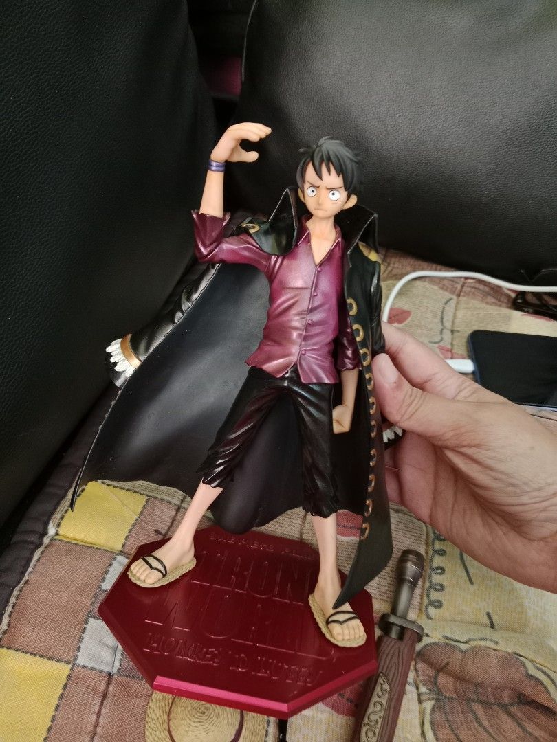 One Piece Monkey D. Luffy Action Figure with Weapon (Category: Figurines & Statues) located in Cabuyao City. Submitted by jcbc0120 (Listing ID 1448346072, Image 3). Description: - High-quality Monkey D. Luffy figure - Features signature straw hat and long coat - Includes a detailed weapon accessory - Ideal for any One Piece fan's collection - Comes with a sturdy red hexagonal display base.