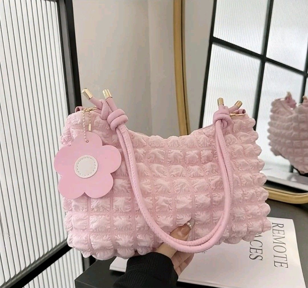 Pink Textured Shoulder Bag with Flower Charm (Category: Shoulder Bags) located in Taguig. Submitted by decluttering.ph2020 (Listing ID 1448332831, Image 1). Description: - Adorable pink shoulder bag - Unique textured material all over - Comes with a sweet flower charm - Soft pink straps with gold accents - Adds a pop of color to any outfit - Ideal size for carrying essentials dimension: 29 x 17 x 9 cm.
