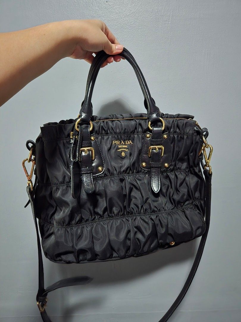 Prada Black Ruched Nylon Leather Trimmed Handbag (Category: Luxury Bags & Wallets) located in Bulacan. Submitted by row01 (Listing ID 1448424791, Image 1). Description: - Japan Pre loved Black Prada Handbag - Ruched Nylon with Leather Trim - Elegant Gold Hardware - Comfortable Top Handles - Detachable Shoulder Strap for Versatility - Secure Zipper Closure - Includes Original Leather Luggage Tag - Ideal for Everyday Use.