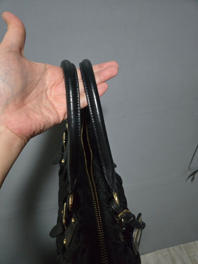Prada Black Ruched Nylon Leather Trimmed Handbag (Category: Luxury Bags & Wallets) located in Bulacan. Submitted by row01 (Listing ID 1448424791, Image 3). Description: - Japan Pre loved Black Prada Handbag - Ruched Nylon with Leather Trim - Elegant Gold Hardware - Comfortable Top Handles - Detachable Shoulder Strap for Versatility - Secure Zipper Closure - Includes Original Leather Luggage Tag - Ideal for Everyday Use.