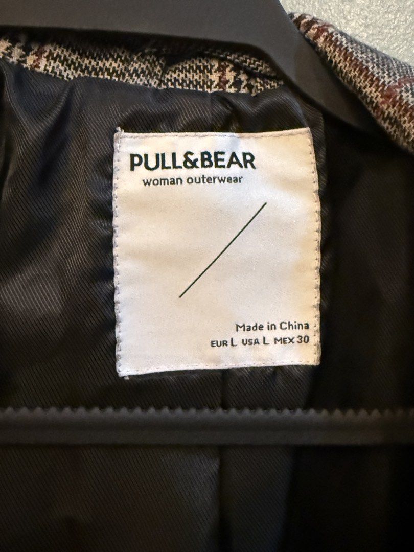 Pull & Bear Plaid Blazer Woman Outerwear (Category: Coats, Jackets and Outerwear) located in Taguig. Submitted by clutterdump (Listing ID 1448443149, Image 2). Description: - Grey plaid blazer from Pull & Bear - Women's outerwear - Double-breasted with two front buttons - Button details on cuffs - Fully lined interior - Ideal for layering over tops or dresses - Versatile for casual and smart occasions.