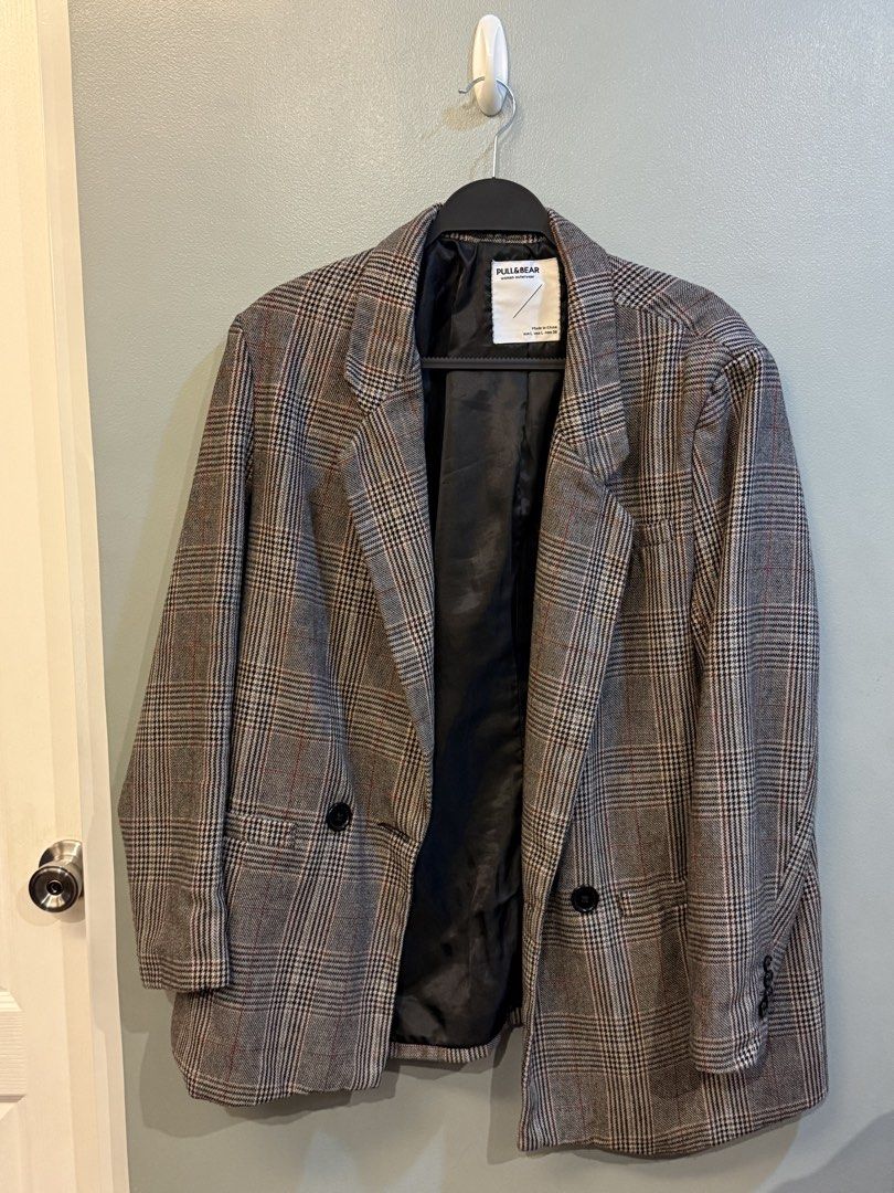 Pull & Bear Plaid Blazer Woman Outerwear (Category: Coats, Jackets and Outerwear) located in Taguig. Submitted by clutterdump (Listing ID 1448443149, Image 1). Description: - Grey plaid blazer from Pull & Bear - Women's outerwear - Double-breasted with two front buttons - Button details on cuffs - Fully lined interior - Ideal for layering over tops or dresses - Versatile for casual and smart occasions.