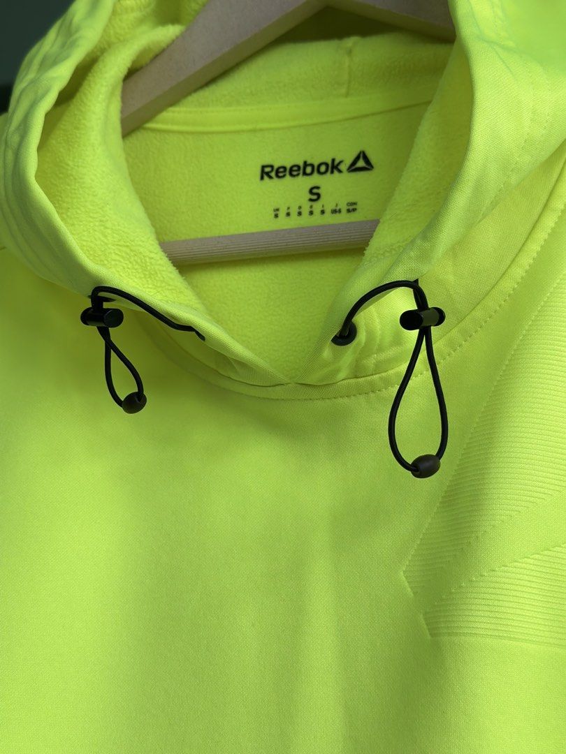 Reebok playwarm hoodie thin fleece (Category: Coats, Jackets and Outerwear) located in Daet. Submitted by thrifthings2018 (Listing ID 1448340673, Image 2). Description: - width 22 Lengtb 28 Bright neon yellow Reebok hoodie - Size S - Drawstring hood - Two side pockets - Contrasting dark grey sleeve panels - Ideal for workouts or casual wear.