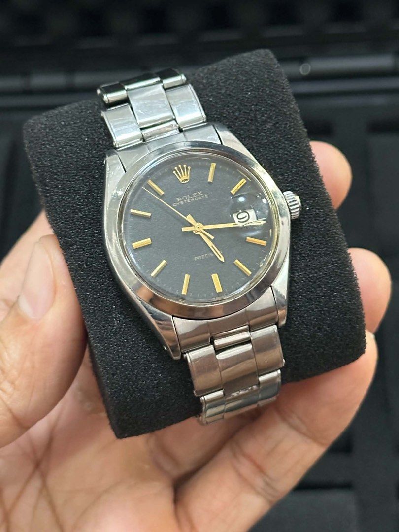 Rolex Oyster Perpetual Precision Watch (Category: Luxury Watches) located in Cabanatuan. Submitted by albertgonzales27 (Listing ID 1448321202, Image 1). Description: - Vintage Rolex Oyster Perpetual Precision - Dark grey dial with gold markers and hands - Stainless steel case and bracelet - Automatic movement - Classic timepiece for watch enthusiasts.