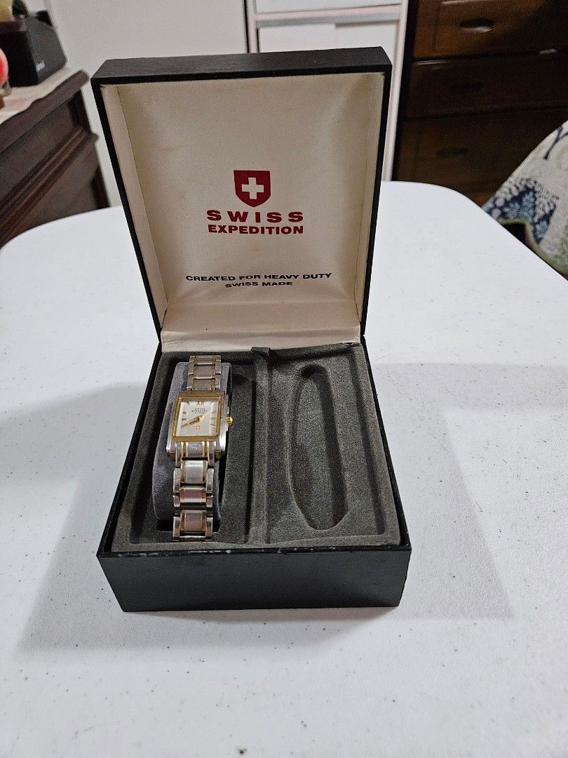Swiss Military Watch with Original Box (Category: Women's Watches) located in Caloocan City. Submitted by rm.diaz (Listing ID 1448419421, Image 1). Description: - Authentic Swiss Military watch - Stylish rectangular face with gold accents - Durable metal band with gold detailing - Includes original presentation box with Swiss Military logo - Ideal for everyday use or as a thoughtful gift.