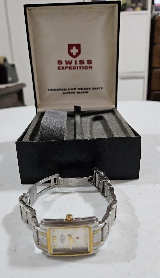 Swiss Military Watch with Original Box (Category: Women's Watches) located in Caloocan City. Submitted by rm.diaz (Listing ID 1448419421, Image 3). Description: - Authentic Swiss Military watch - Stylish rectangular face with gold accents - Durable metal band with gold detailing - Includes original presentation box with Swiss Military logo - Ideal for everyday use or as a thoughtful gift.
