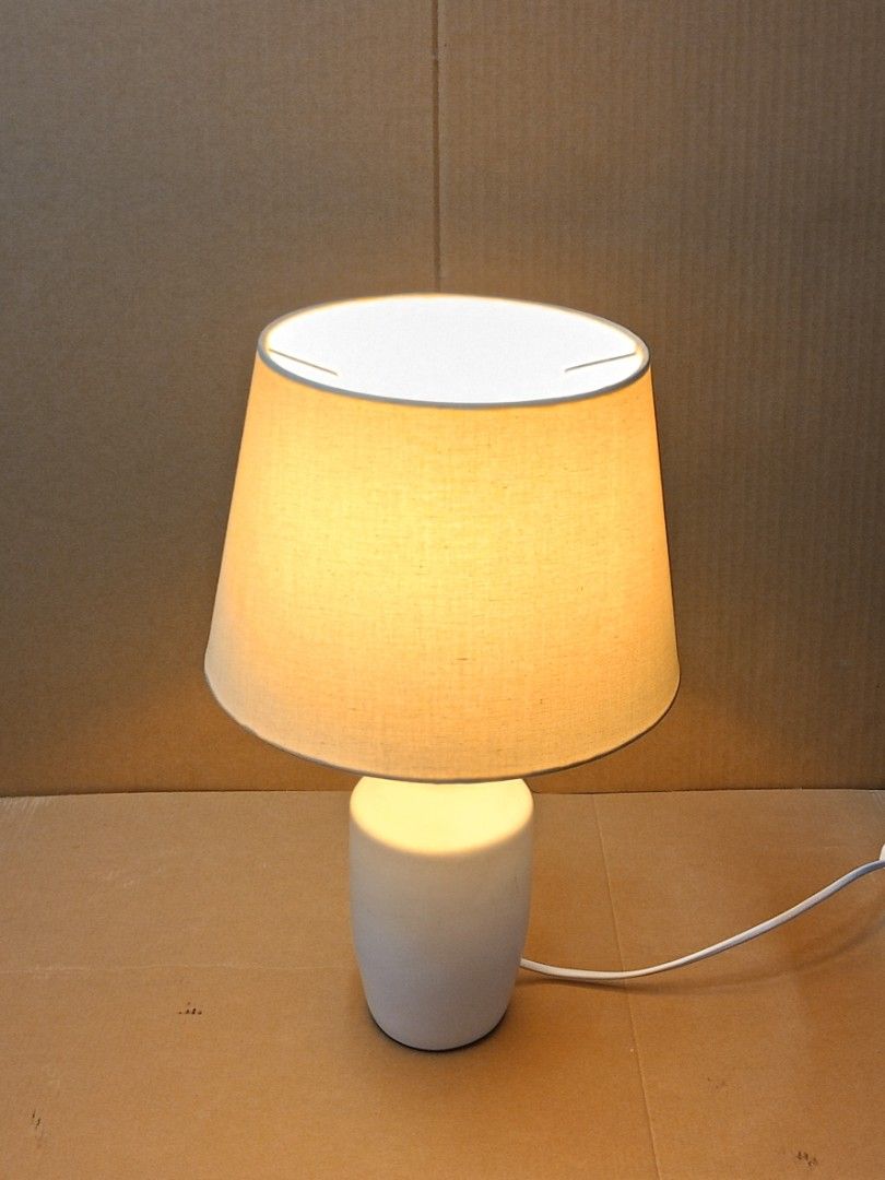 Table Lamp (Category: Lighting) located in Kuala Lumpur. Submitted by live.alex68 (Listing ID 1448284591, Image 3). Description: - White table lamp with beige shade. - Works well, tested and function. - Perfect for bedside table or desk. - Simple and classic design. Height - 15.5 inches.